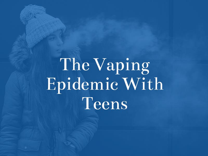 teenage girl blowing out smoke
